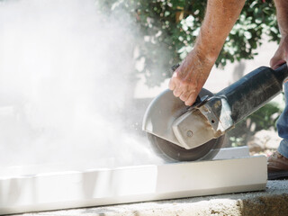 Bricklayer anonymouscutting plaster with construction tool