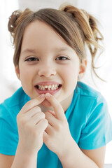 Fototapeta premium The kid lost a tooth. Baby without a tooth. Portrait of a little girl no tooth. High quality photo