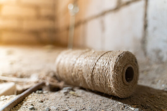 A skein of jute thread close-up lies on the floor