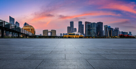 Empty square floor and city skyline with modern commercial buildings in Hangzhou at sunset, China. - obrazy, fototapety, plakaty