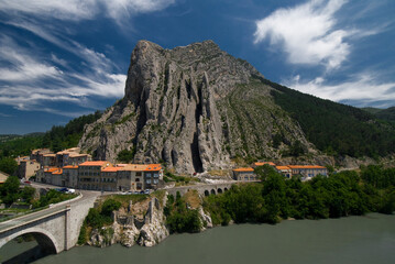 Houses at the base of Rocher de la Baume - high impressive rock in Sisteron - charming town on...