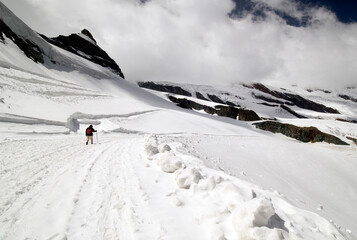 single person hiking in snow in high Alps, Saas Fee, canton Valais, Switzerland, Europe
