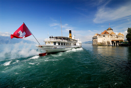 Steamboat Passing Chillon Castle Occupied Since Bronze Age, Located Near Veytaux, Close To Montreux Between Lake Geneva Shore And Alps, Vaud, Most Visited Historic Monument In Switzerland, Europe