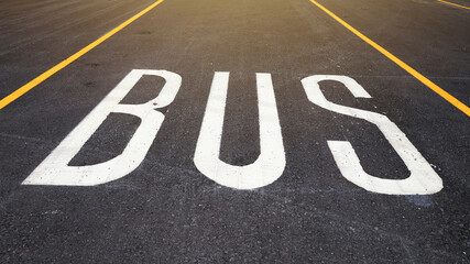 The perspective bus stop parking or bus lane is lined with black asphalt.
