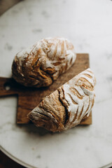 two halves of cut bread top view. craft bread made with sourdough. buckwheat bread with patterns on the top.