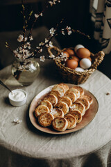 ukrainian or russian cheesecakes on a platter top view. cottage cheese dessert with sour cream on the table.