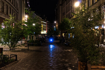 Naklejka premium Biker driving at night through streets
