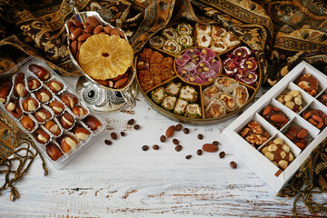 Eastern sweets with nuts, candy, dates in box background,