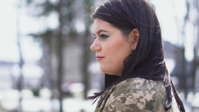 Brunette girl in military camouflage uniform. Armed Forces of Ukraine.