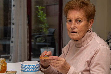 senior woman preparing a morning breakfast at home