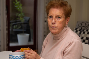 senior woman having breakfast bowl of milk and toast