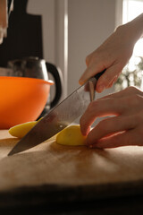 Cooking. Close-up of a kitchen knife in female hands. A woman cuts vegetables for soup. A knife...