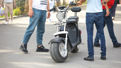 Fototapeta Electric big wheel scooter in the city. For rent obraz