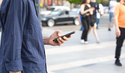 Caucasian man using smartphone in the city.