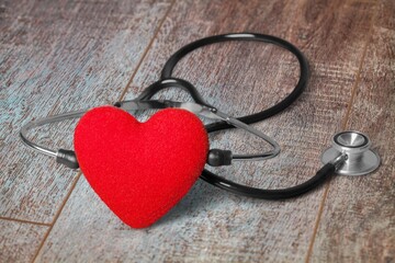 Red heart with medical stethoscope, heart health concept, insurance concept, World heart day.