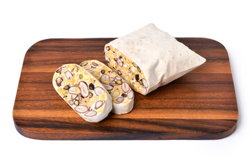 Fresh raw tempeh (Tempe) on wooden cutting board isolated on white background.