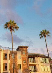 Vertical Puffy clouds at sunset Oceanside building rentals in a low angle view at California
