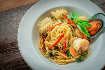 Seafood spaghetti with large shrimp on spaghetti on a plate, ready to serve.