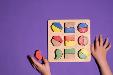 Educational toys, Cognitive skills, Montessori activity. Closeup: Hands of a little Montessori kid...