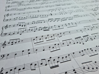 Music notes background. Musical concept macro view of white score sheet music