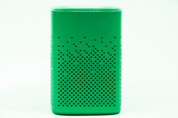 portable green speaker on white background.the concept of listening to music. wireless audio playback device.