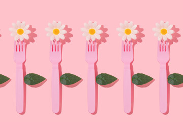 Spring creative pattern with pastel pink fork, white flower heads and leaves on pastel pink background. 80s or 90s aesthetic fashion food restaurant concept. Minimal romantic summer idea.