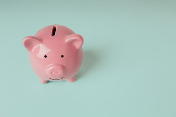 Piggy bank on a blue background with copy space