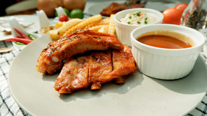 Grilled and smoked pork ribs with barbeque sauce on a dish