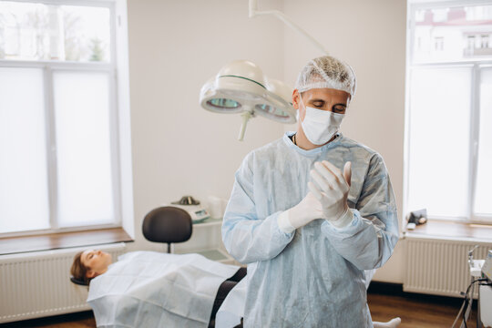 Doctor Surgeon putting on white sterilized surgical glove in hospital operating room