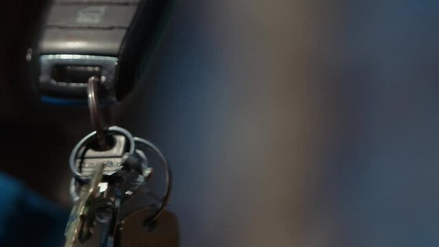 A closeup of a set of keys dangling in the air.