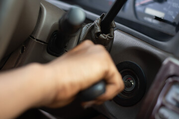 black person putting a key into the car ignition