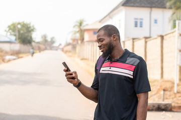 african man using his phone outside