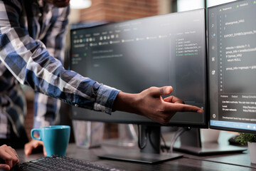 Blockchain engineer pointing out mistake in network security software line code. Cybernetics...