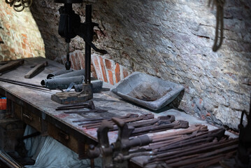 Old blacksmith's workshop, museum in Masovia. Hammers, horseshoes and various tools of a blacksmith.