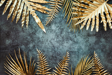 Creative nature gold layout made of tropical leaves. Summer concept. Fern Palm and monstera leaf on...