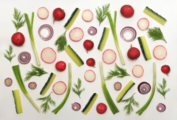  Fresh vegetable vitamin set  from green onions , radishes, slices cucumber , green parsley, slices blue onion on white background. Top view .  seamless pattern of  spring vegetables.