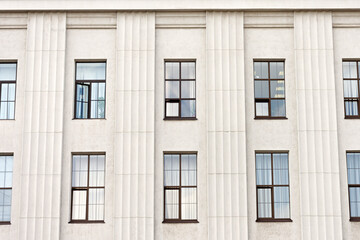 Elongated windows with columns exterior building in gray.