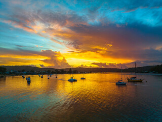 Aerial sunrise waterscape with boats, colour and clouds