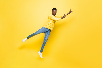 Fototapeta na wymiar African man jumping and pointing away