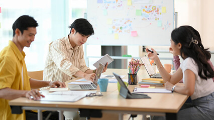 Smart and handsome male worker looks over the financial data in the report