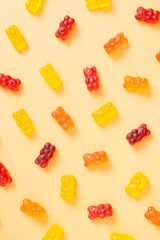 Colored jelly bears on an orange background. Top view
