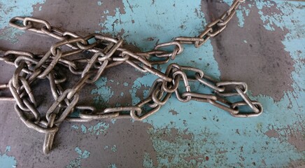 Close-up of an irregular scrap metal chain on a blurred background