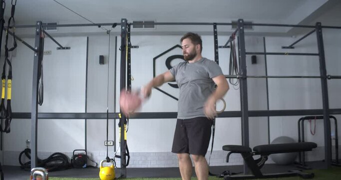 Caucasian man exercising in a gym practicing Kettlebell