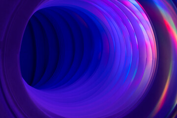Abstraction, corrugated pipe with circles of rainbow light
