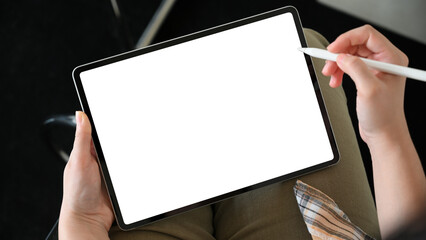 A woman hands holding stylus pen, drawing on digital tablet screen.