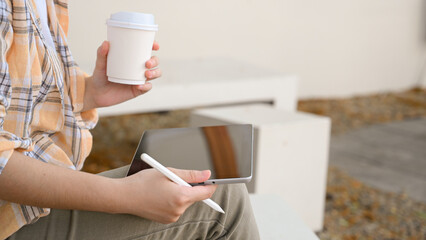 Female freelancer relaxes chill out at the cafe while using digital tablet.