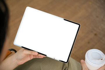 A digital tablet touchpad white screen mockup in a women's hand.