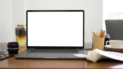 Notebook laptop computer white screen mockup on modern office desk