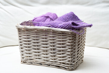 white wicker basket with knittin