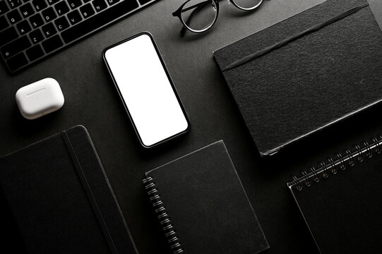 Modern black office workspace background with office accessories and devices mockup.